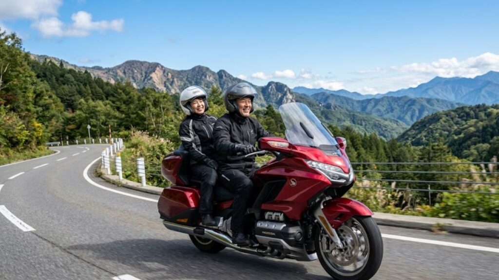 晴天の下、山岳道路をタンデムで快適にクルージングするホンダ・ゴールドウイング